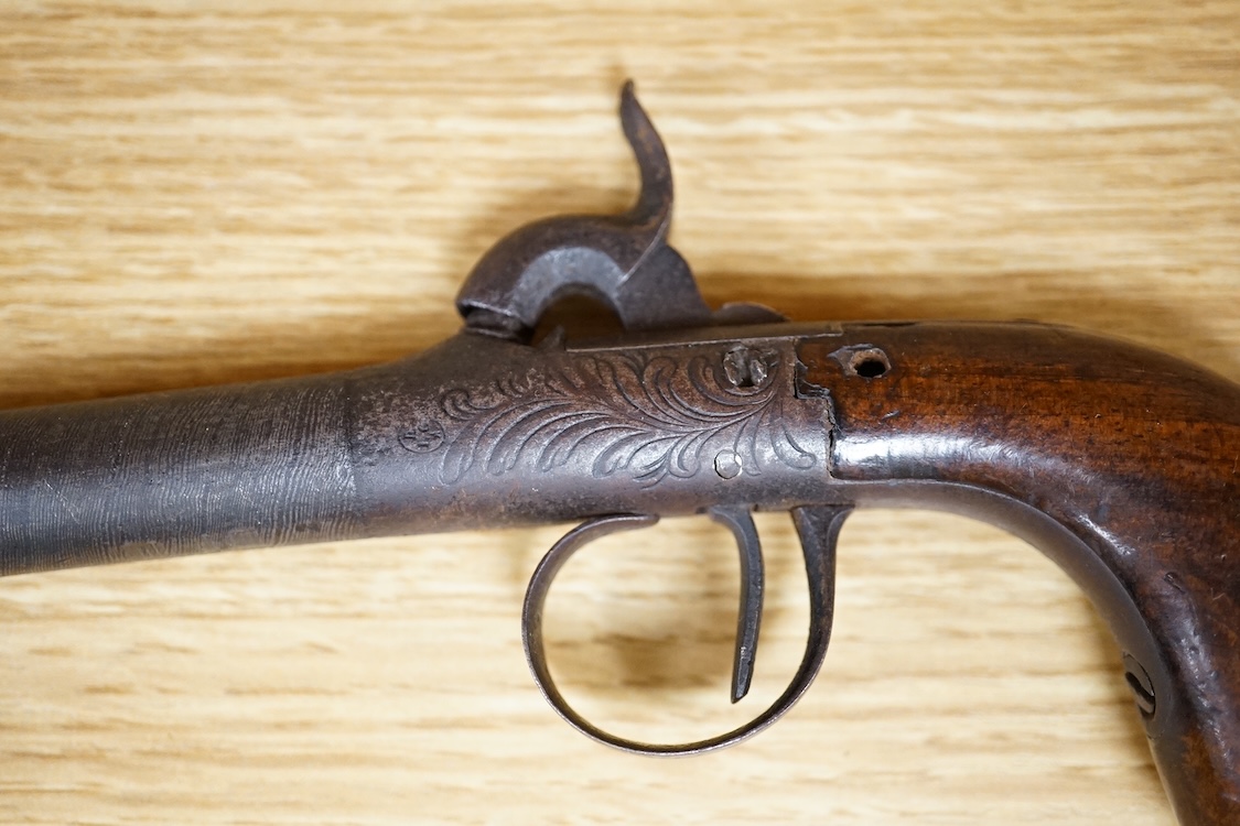 A boxlock percussion pocket pistol with turn off barrel etched with ribbon twist, engraved rounded frame, liege proved, with rounded walnut butt